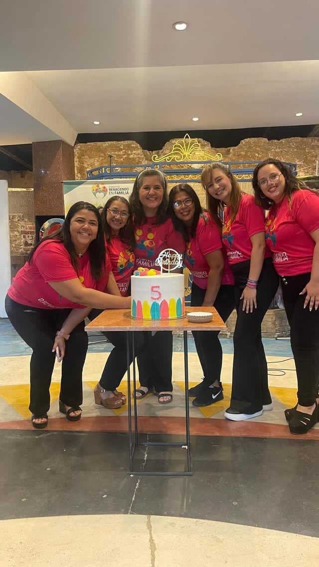 back view of woman wearing a backpack and beanie waiting to cross the road on a busy street at night in New York City, USA